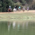 Horseback riding along Dream Lake at the ranch in Texas.